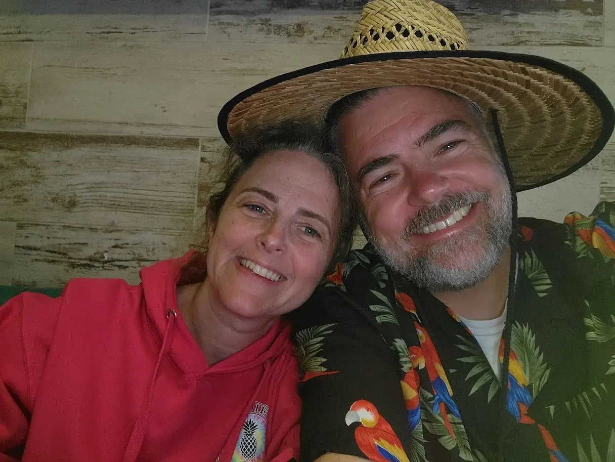 A couple on a deck at sunset